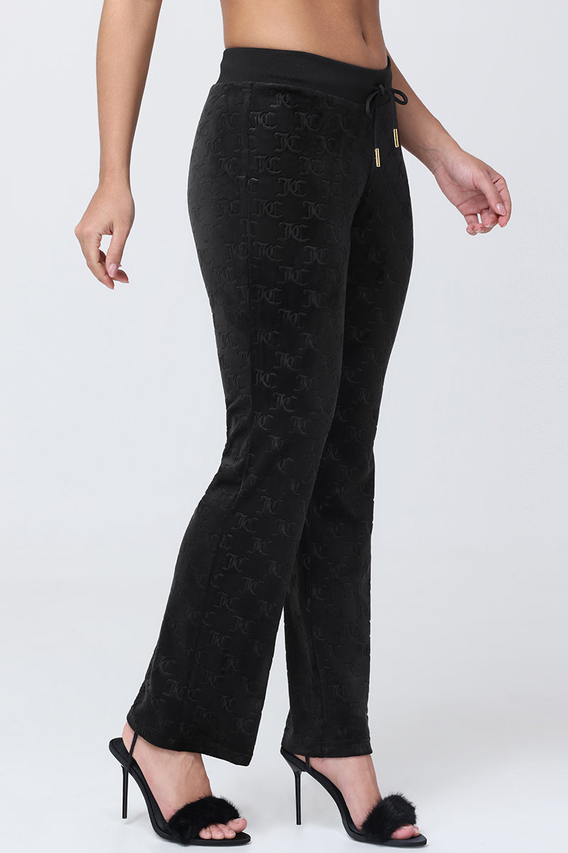 Black flared Embossed Velour Track Pants featuring an all-over embossed logo pattern and a drawstring waistband.