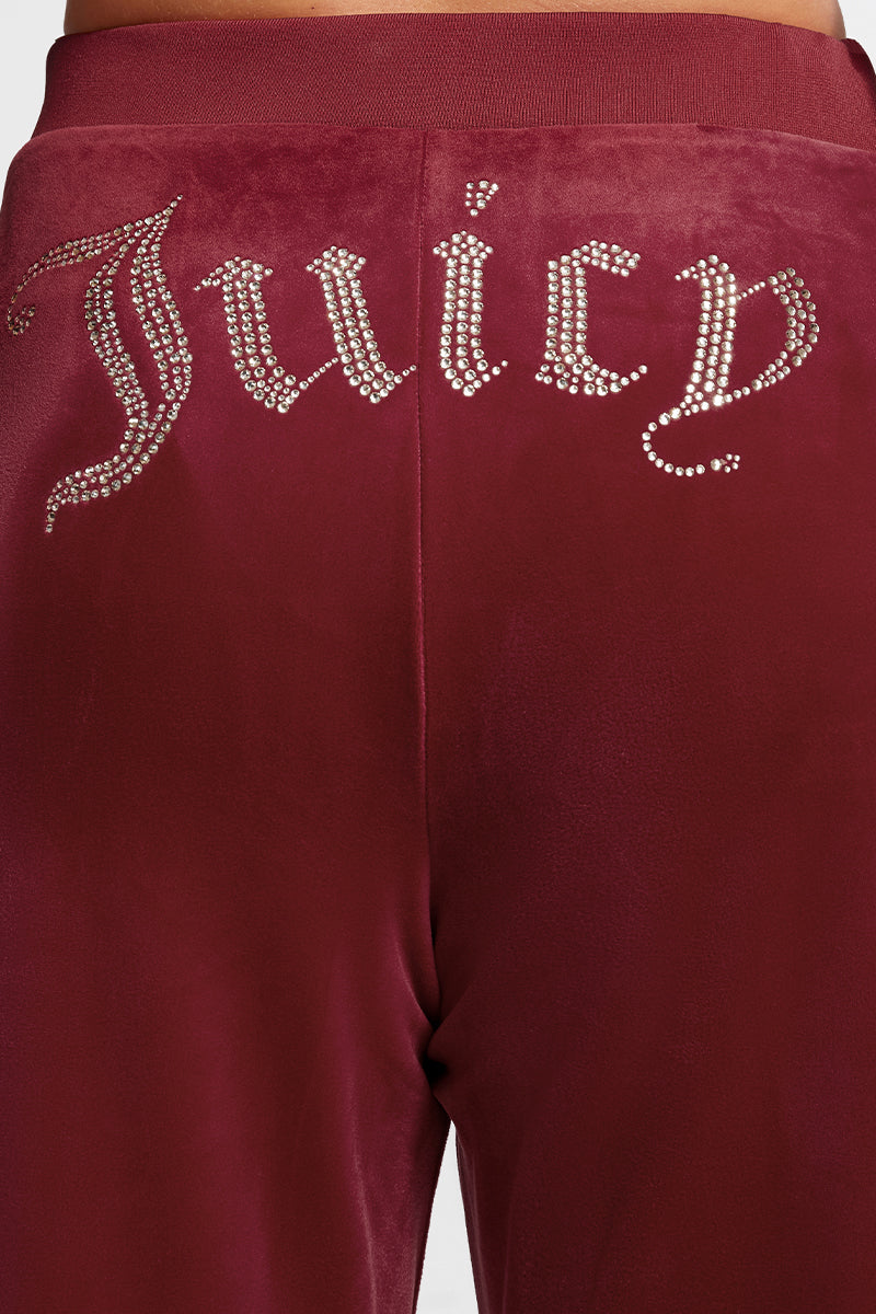 Close-up of the back of the Plus-Size OG Big Bling Velour Track Pants featuring a sparkling rhinestone Juicy embellishment across the waistband.