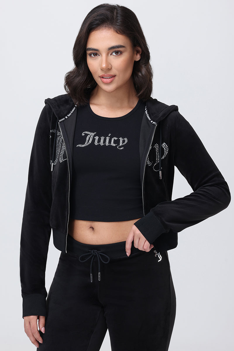 A person wearing a Small Bling High Neck Crop Tank with rhinestone-embellished Juicy text and a matching black zip-up hoodie.