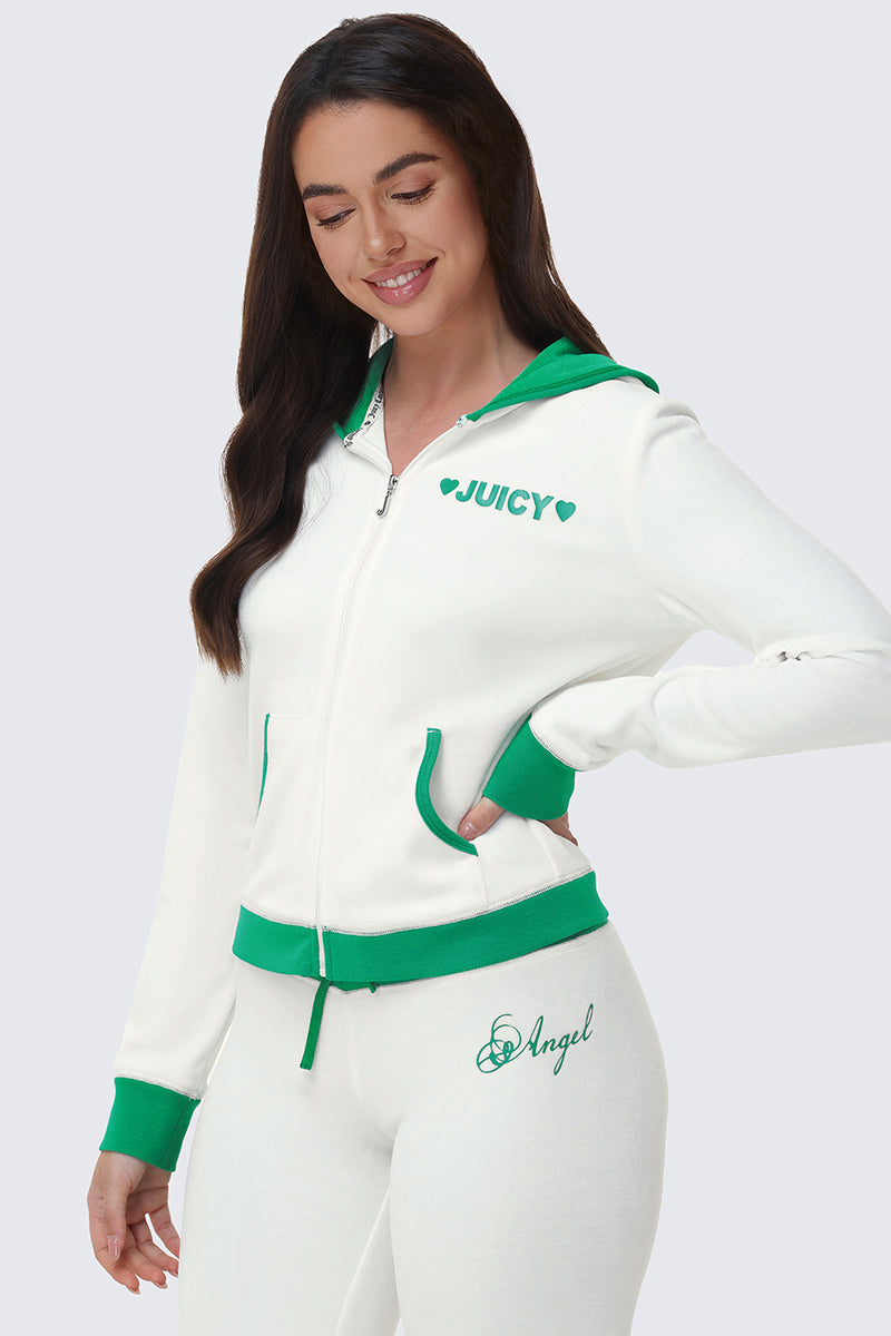 A woman wears a white Contrast Trim Logo Hoodie with green trim and chest logo. Her pants read "Angel" in script on the hip as she smiles with her eyes closed.