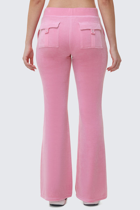 A person is seen from the back wearing Heritage Cotton Velour Track Pants in light pink, featuring a high waist, flared legs, and two flap pockets, with their arms relaxed at their sides against a plain light gray background.