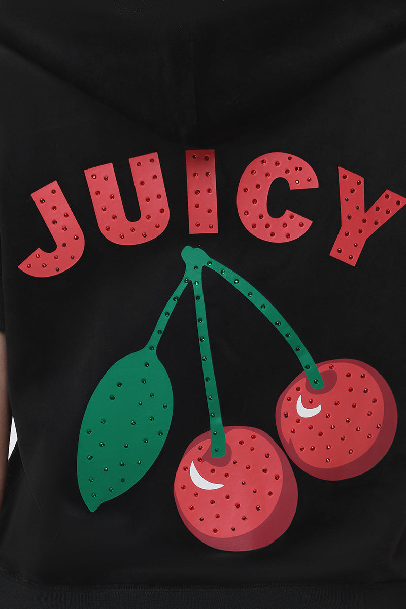 The Cherry Bling Velour Hoodie is a black short-sleeve velour hoodie with “JUICY” in bold, rhinestone-studded red letters above sparkling red cherries with a green leaf graphic.