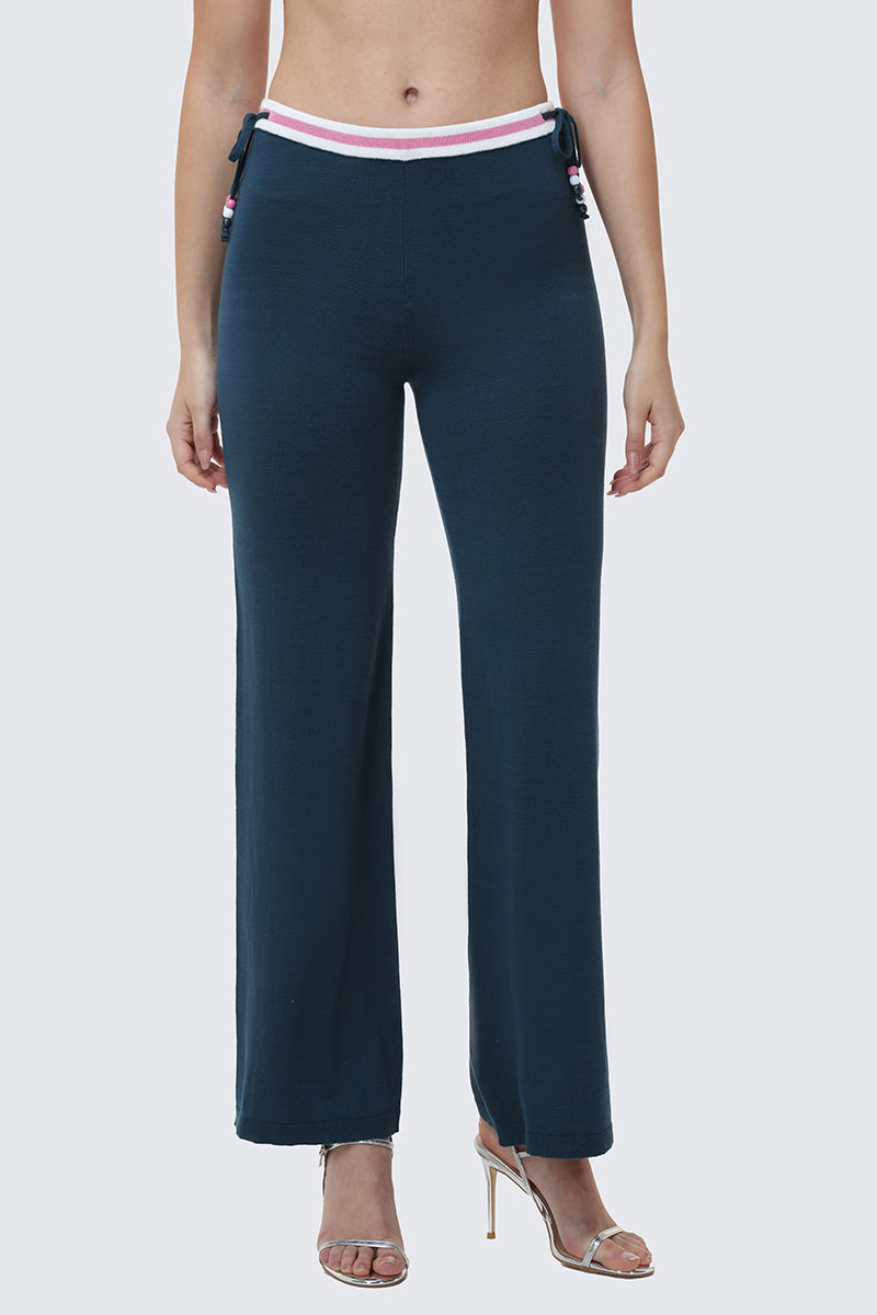 A person wears Big Bling Wide Leg Pants featuring a ribbed fabric, contrast striped waistband, side ties, and clear high-heeled sandals. The cropped photo focuses on the lower torso and legs below the chest.