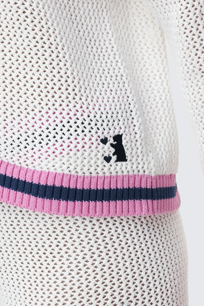 Close-up of the Mesh Zip-Up Hoodie in white sheer knit, featuring a pink and navy striped waistband and a small black stitched dog-and-ball detail near the waist.