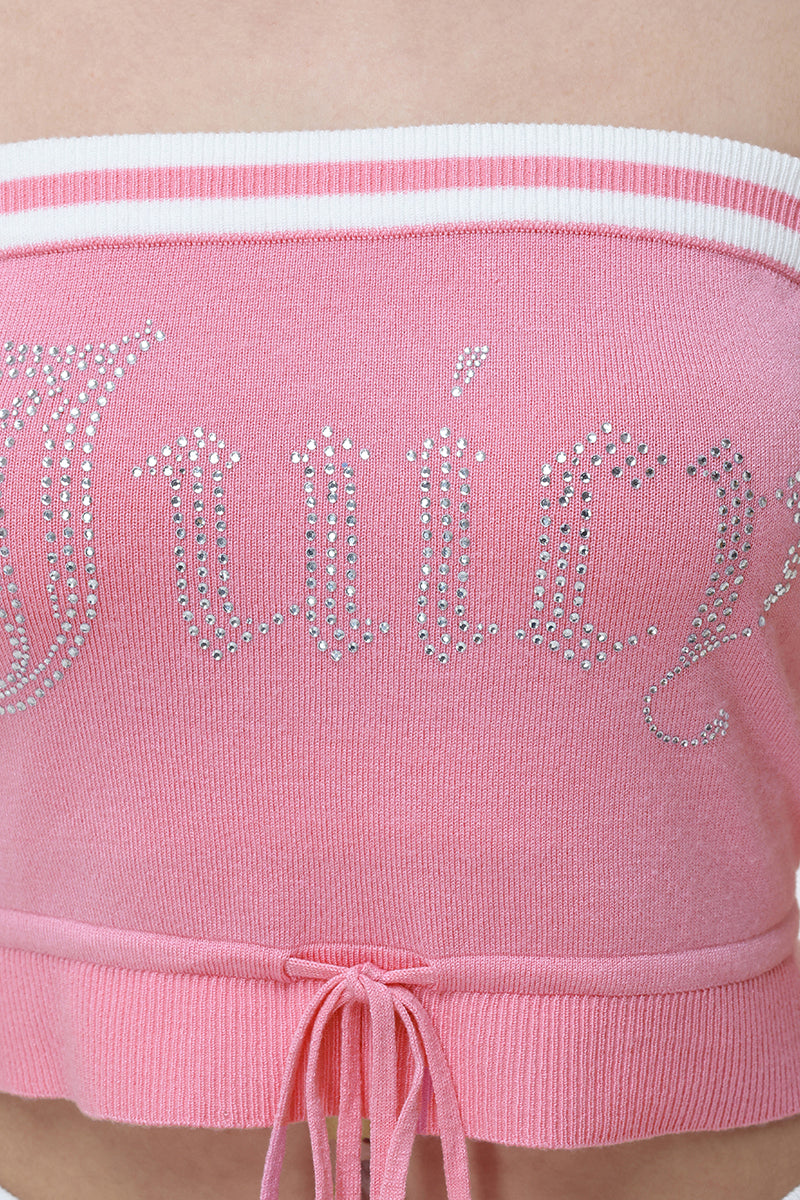 A close-up of the Big Bling Tube Top, a pink strapless top with white trim, "Juicy" in rhinestones on the front, and a drawstring bow at the bottom hem.
