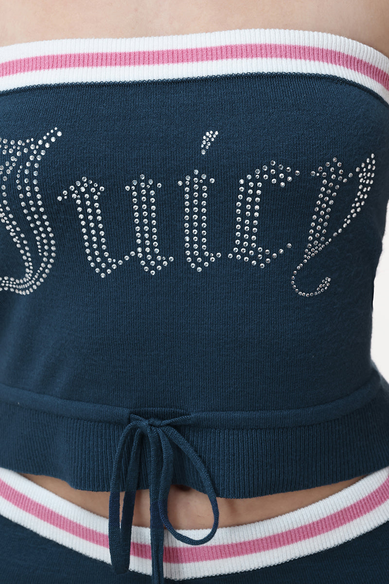 Close-up of a person wearing the Big Bling Tube Top, a navy blue strapless top with "Juicy" in rhinestones, featuring pink and white trim and a waist drawstring.