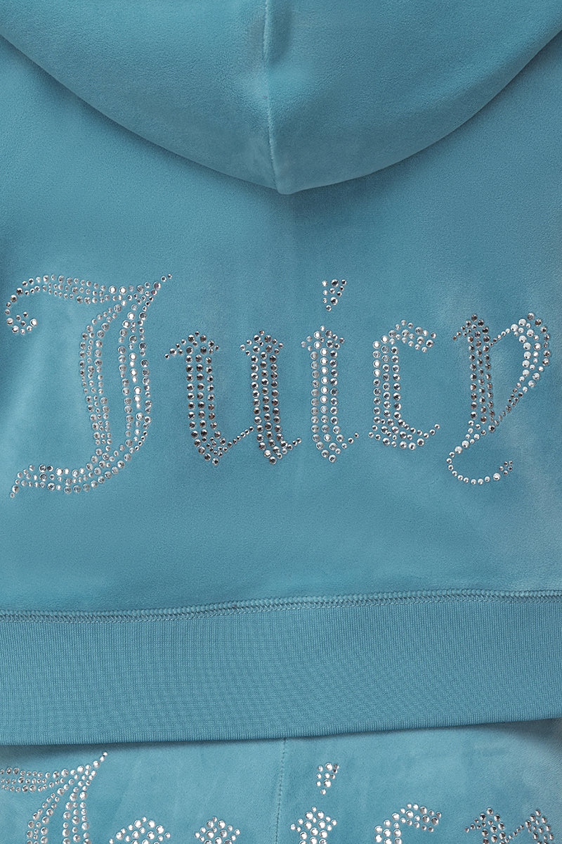 Close-up of the OG Big Bling Velour Hoodie in blue, featuring "Juicy" spelled out on the back in silver rhinestone embellishments with a decorative font.