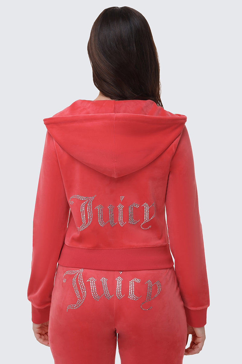 A person wears the OG Big Bling Velour Hoodie in pink, shown from the back. Rhinestone Juicy embellishments decorate the jacket and pants. The luxe hood is up but not covering the head.