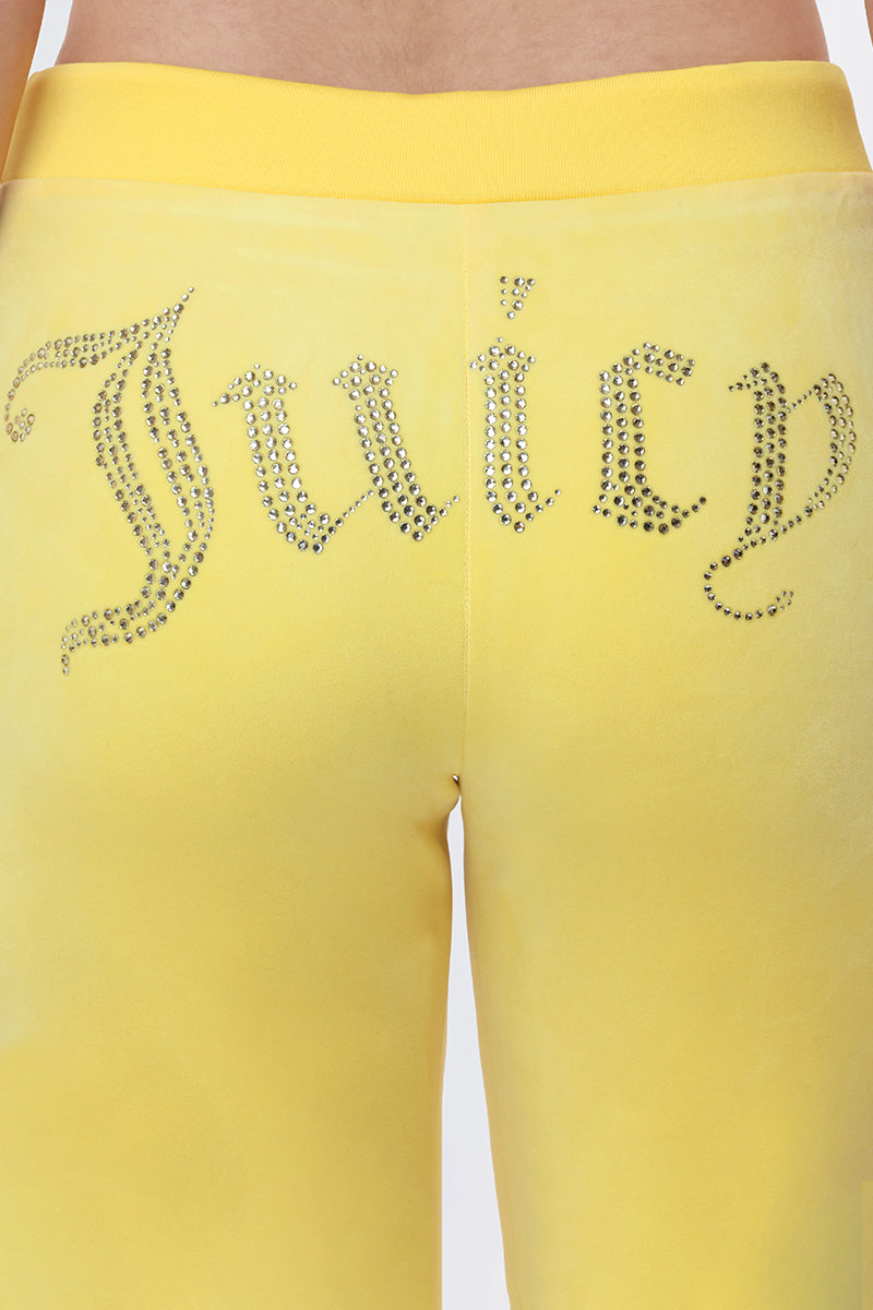 Close-up of the back of OG Big Bling Velour Track Pants in yellow, featuring a Y2K-inspired "Juicy" embellishment in sparkling rhinestones across the seat.