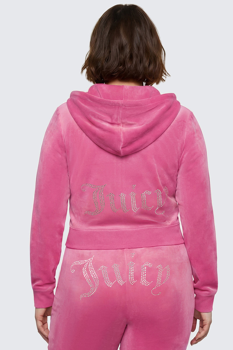 A person wearing the Plus-Size OG Big Bling Velour Hoodie with a bedazzled Juicy logo in rhinestones on the back, paired with matching pants and shown from behind against a plain gray background, captures an iconic Y2K vibe.