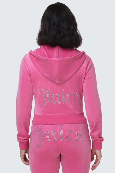 A person wearing the OG Big Bling Velour Hoodie—a pink velour tracksuit with a bedazzled hoodie and the rhinestone Juicy logo on the back of both the hoodie and pants—channels an iconic Y2K vibe when viewed from behind.
