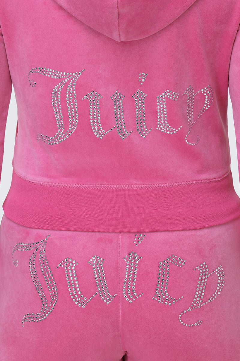 Wearing the OG Big Bling Velour Hoodie in pink, featuring a sparkling rhinestone Juicy logo on the back, this look captures classic Y2K style.