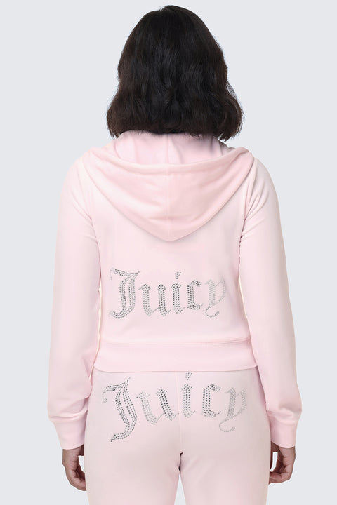 Wearing the OG Big Bling Velour Hoodie in light pink, this person is seen from behind against a light gray background, with the sparkling Juicy logo emblazoned in rhinestones across the back—a true nod to Y2K style.