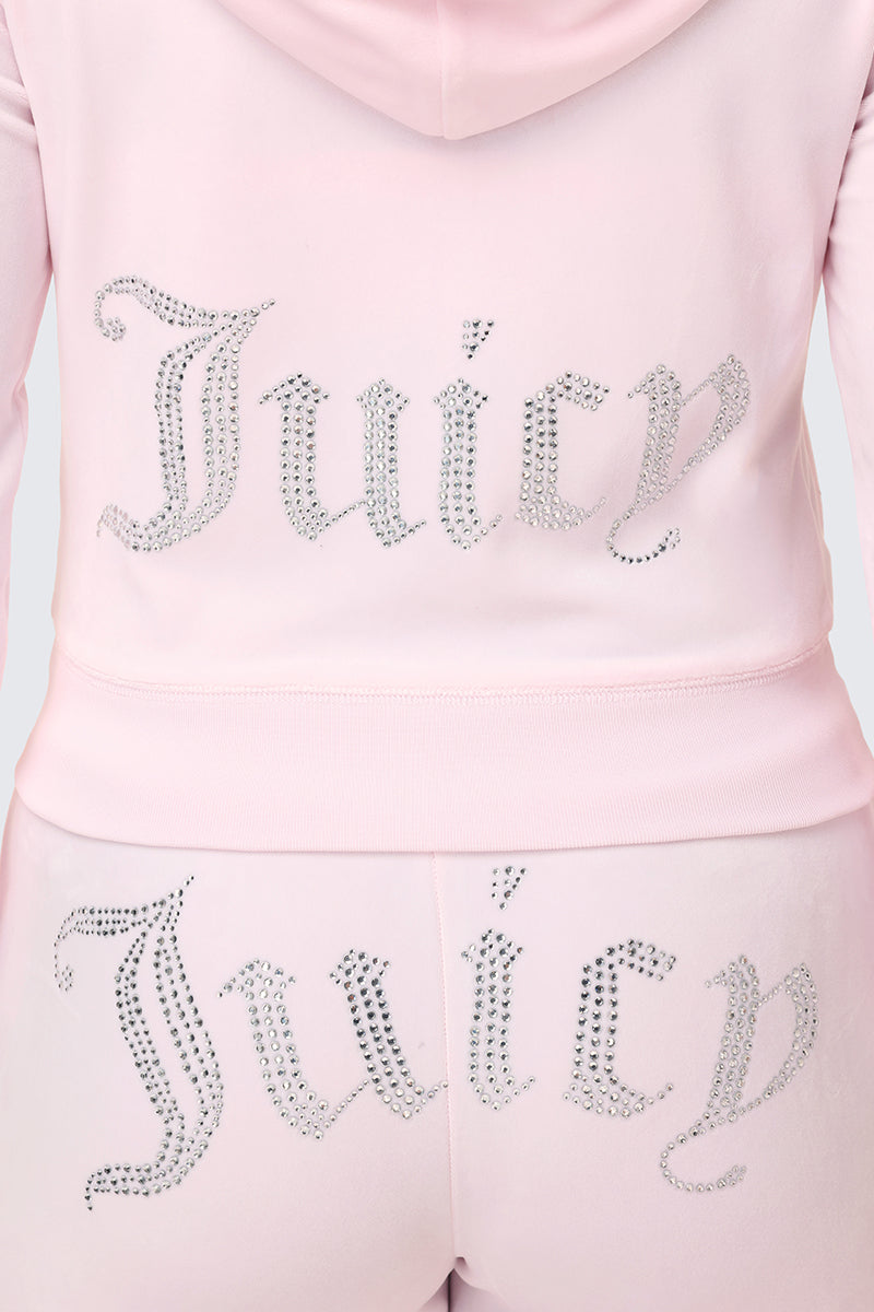Back view of a person wearing the Plus-Size OG Big Bling Velour Hoodie in light pink, featuring a rhinestone Juicy logo bedazzled on the back, capturing the iconic Y2K style.