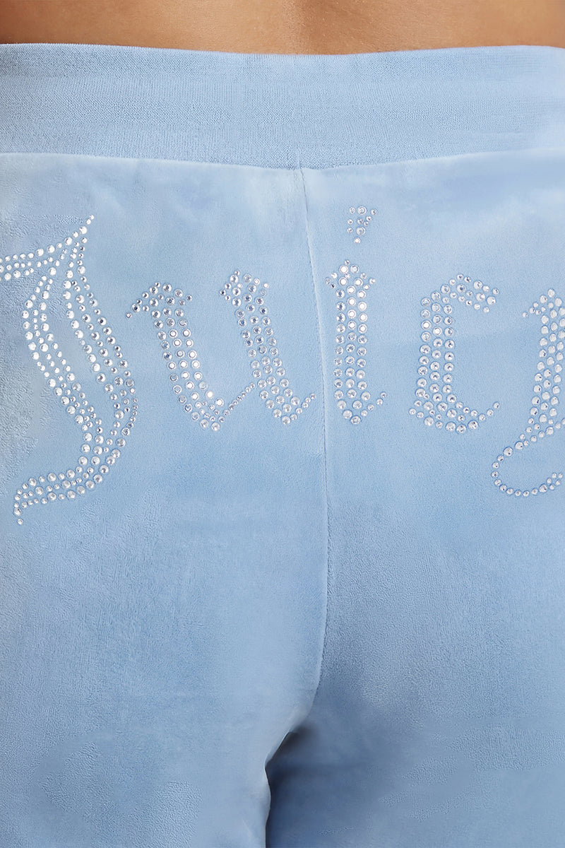 Close-up of the back of the Plus-Size OG Big Bling Velour Track Pants in light blue, featuring a sparkling Juicy rhinestone embellishment across the waistband—perfect for channeling iconic Y2K style.