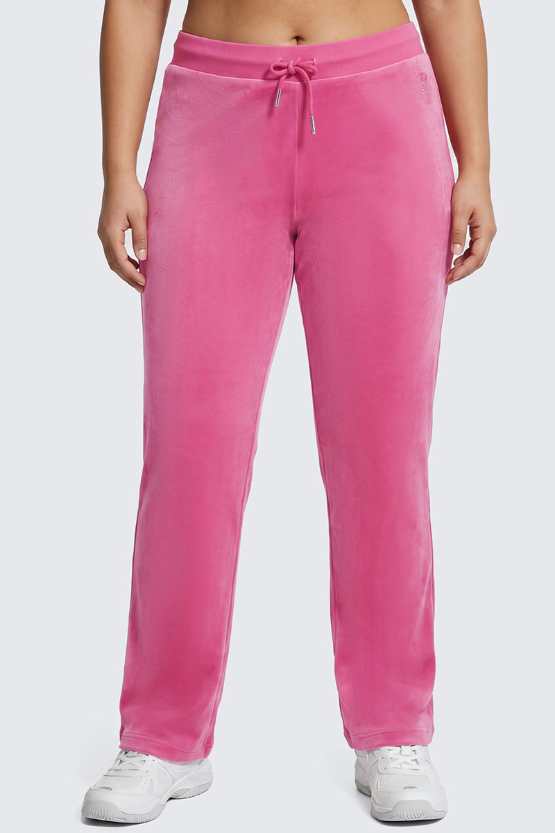 A person wearing the Plus-Size OG Big Bling Velour Track Pants in bright pink, featuring a drawstring waist, paired with white sneakers and a bare midriff, stands against a plain light background for the perfect nod to Y2K style.