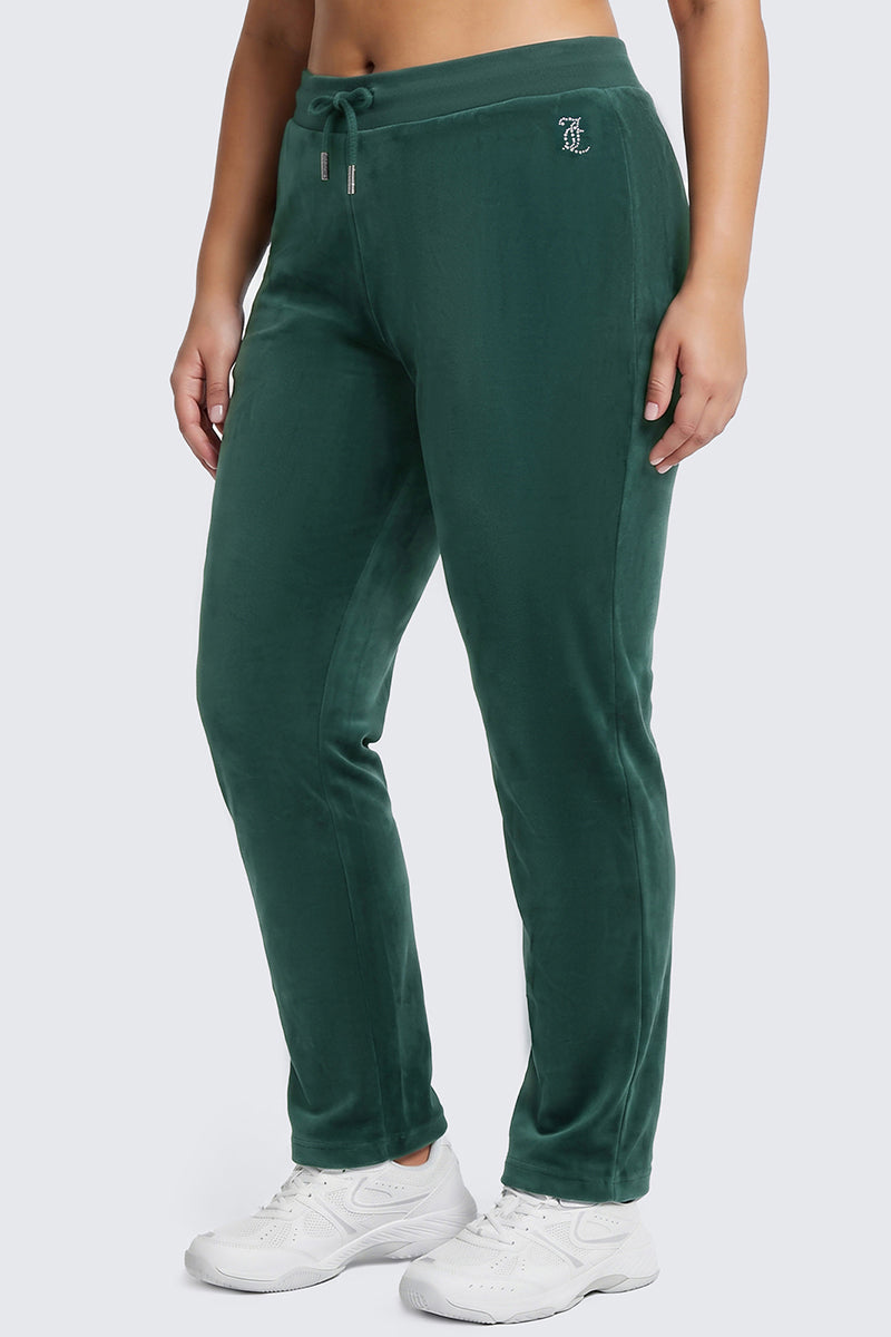 A person wearing the Plus-Size OG Big Bling Velour Track Pants in juicy green, featuring a drawstring waist and paired with white sneakers, stands against a plain light gray background for a classic Y2K-inspired look.