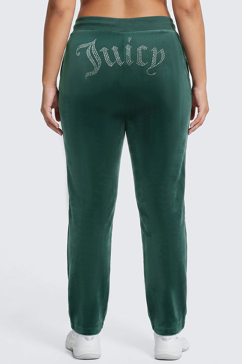 A person wearing the Plus-Size OG Big Bling Velour Track Pants with “Juicy” spelled out in rhinestones across the back, serving major Y2K vibes as they stand with their back to the camera.