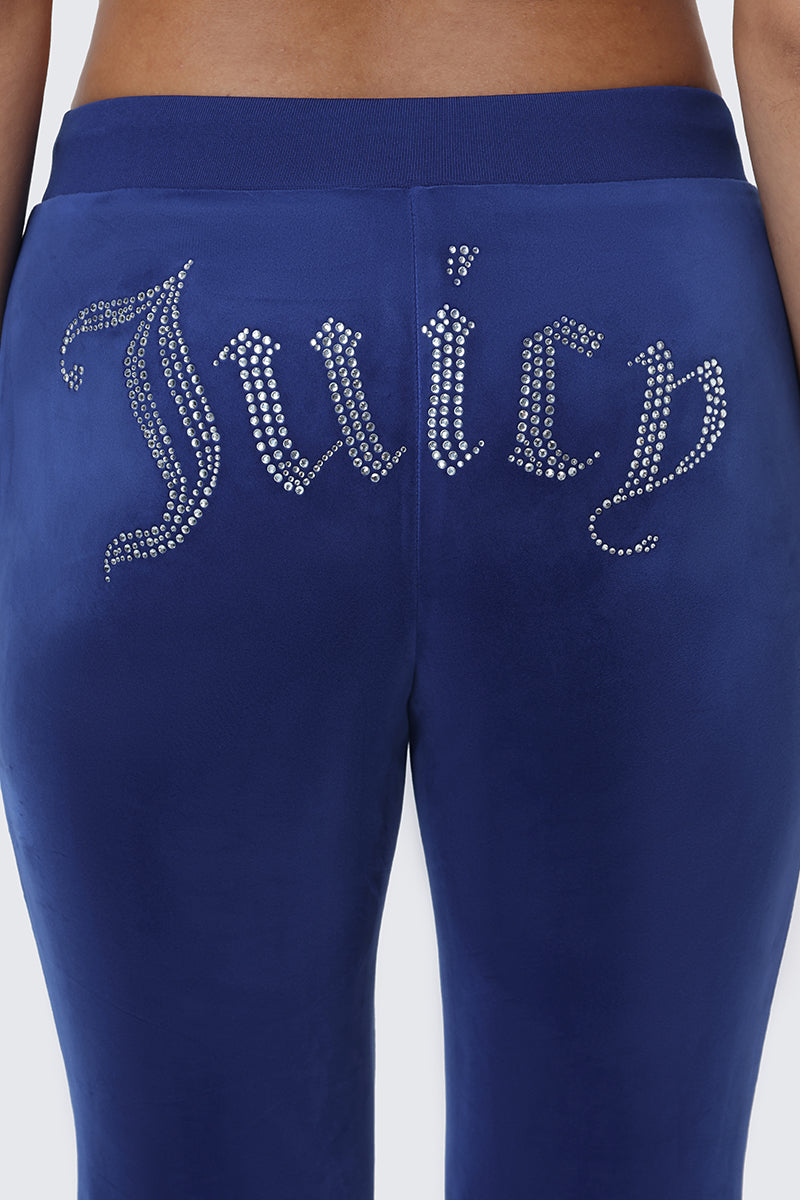 Close-up of the OG Big Bling Velour Track Pants in blue, featuring a dazzling Juicy rhinestone embellishment across the back for a signature Y2K look.