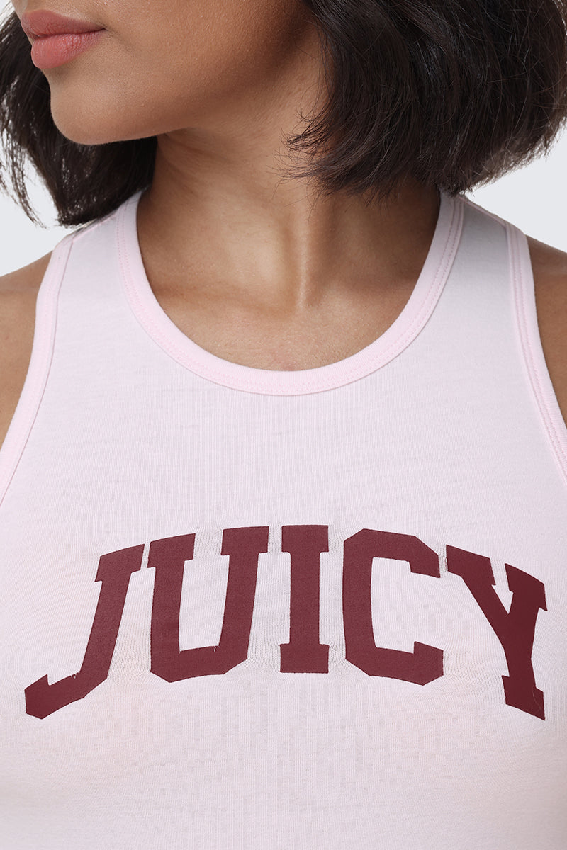 A person with short dark hair wears the Collegiate Juicy High Neck Tank Top in light pink, featuring "JUICY" printed in large maroon letters across the chest for a bold collegiate style.