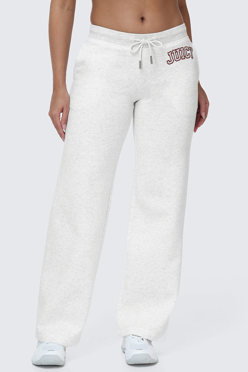 Wearing the Small Bling Fleece Wide Leg Pants in light gray featuring a drawstring waistband and "JUICY" in red lettering near the left pocket, this person pairs them with white sneakers.