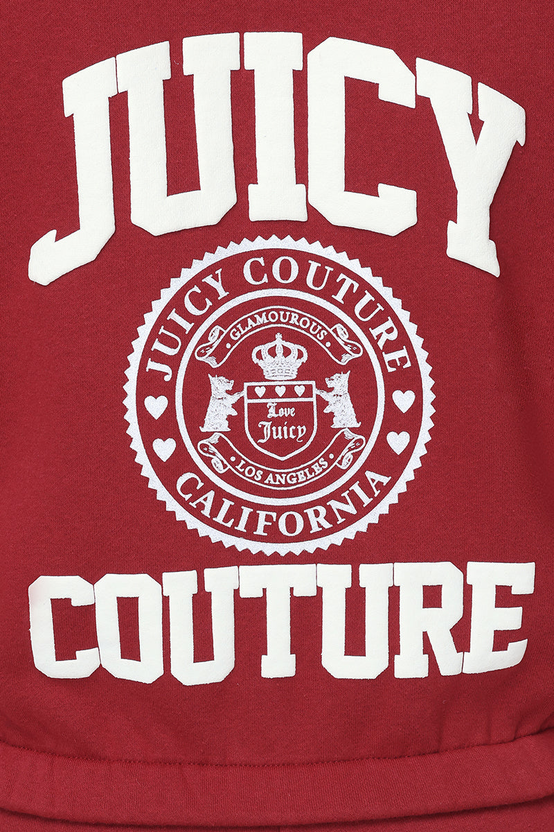 The Scottie Fleece Quarter Zip Sweatshirt is a red cropped fleece featuring bold white "JUICY COUTURE" text and a central circular Scottie crest graphic that reads "Juicy Couture California," complete with decorative details and small hearts.