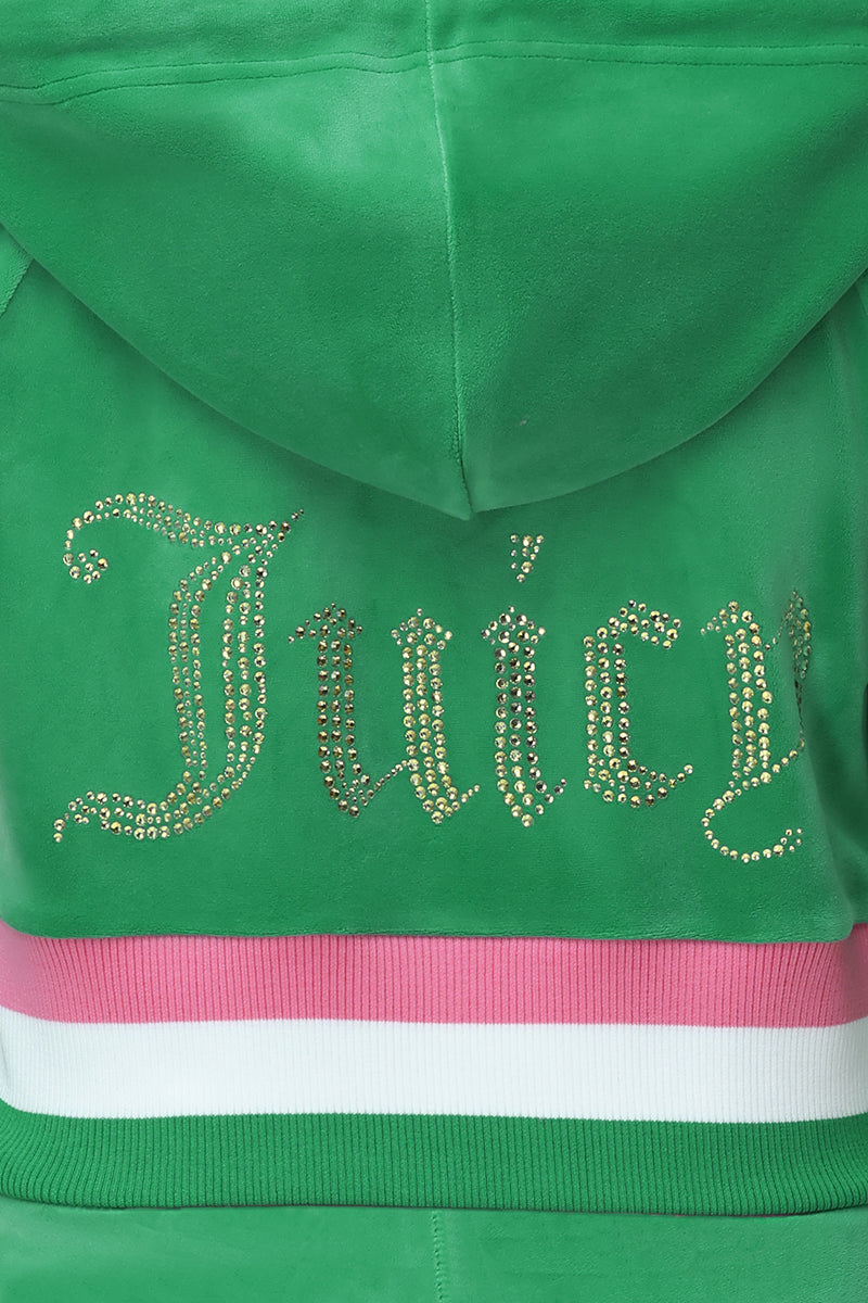 The Heritage Stripe Bling Velour Zip Hoodie features a green velour design, a sparkling rhinestone "Juicy" logo on the back, and pink and white striped waistband accents.