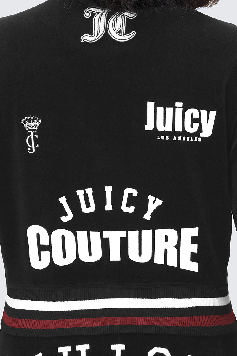 Introducing the Mixed Logo Cotton Velour Bomber Jacket: crafted from black cotton velour, this sporty bomber features bold white Juicy Couture logos, a crown emblem, and JC monogram on the back. The waist is finished with eye-catching red, white, and black striped trim for a striking contrast. Signature Juicy graphics complete the look from every angle.