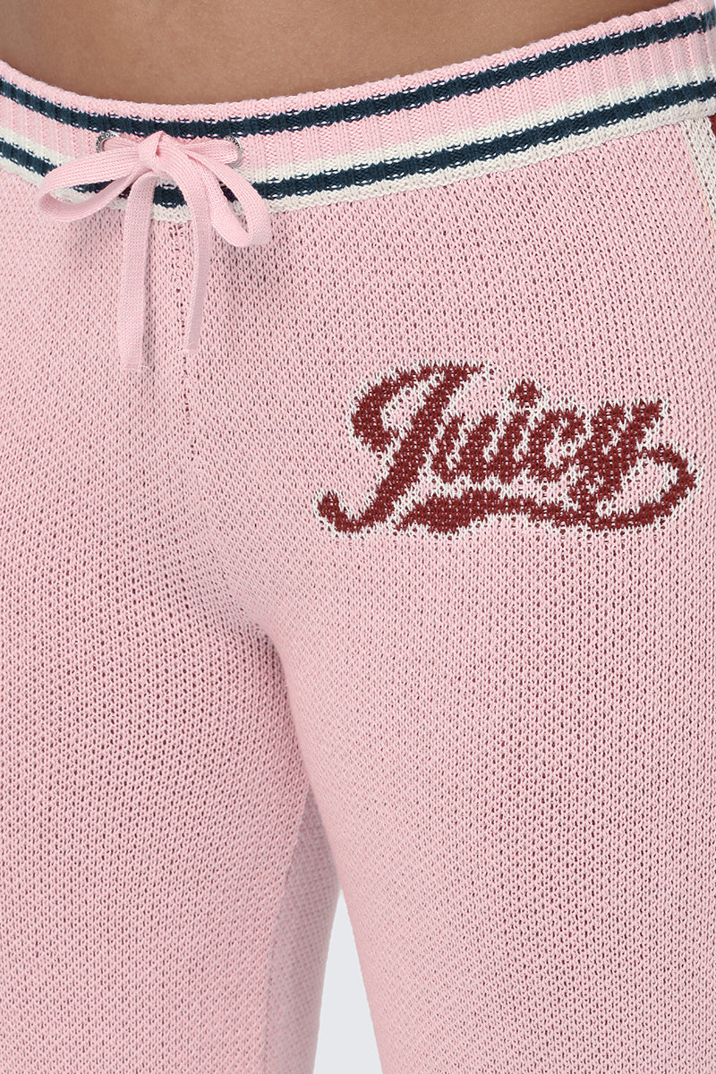 Close-up of the Contrast Knit Wide Leg Pants in pink, featuring a drawstring waist and the Juicy script logo embroidered in red on the left hip—an effortlessly sporty essential.