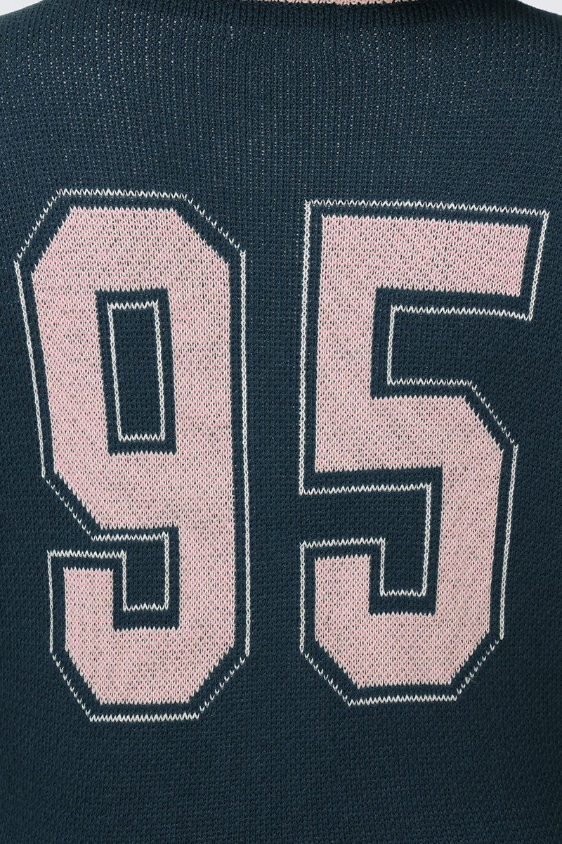 A close-up of the Collegiate Knit Bomber Jacket in dark blue, featuring large pale pink numbers "95" outlined in white prominently displayed on the front.
