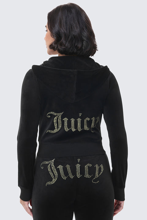 A person wears a black OG Big Bling Ribbon Hoodie and matching pants, both featuring the word Juicy in rhinestones on the back and the lower portion of the pants.