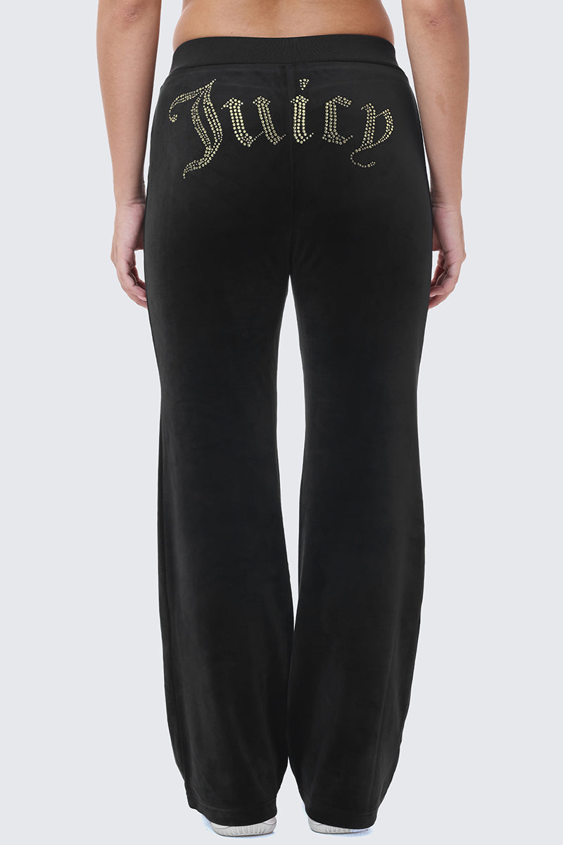 OG Big Bling Ribbon Track Pants in black velour, featuring bling accents and the word Juicy spelled out in gold rhinestones across the back.