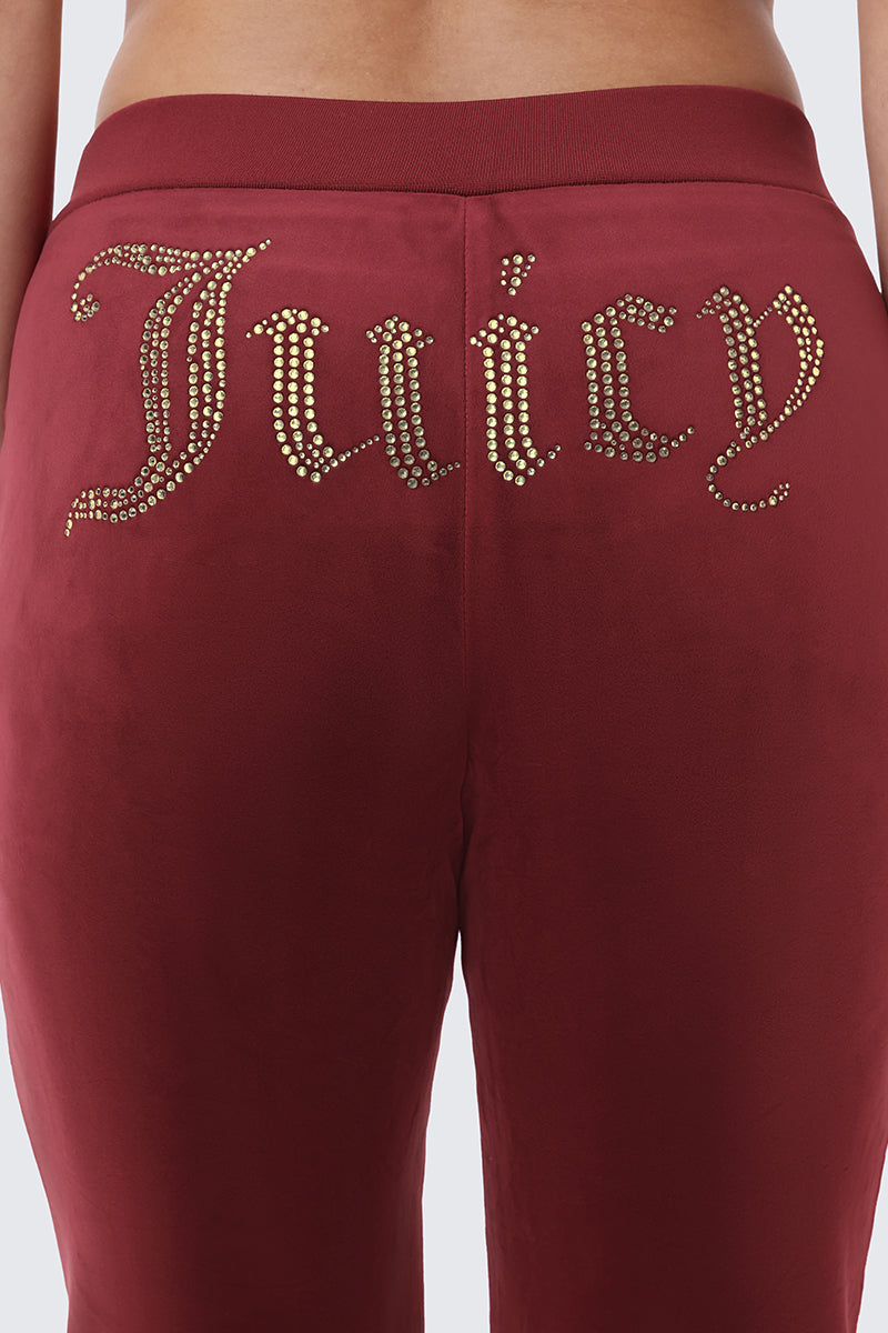 OG Big Bling Ribbon Track Pants in burgundy featuring the word Juicy written in gold rhinestone bling accents across the back.