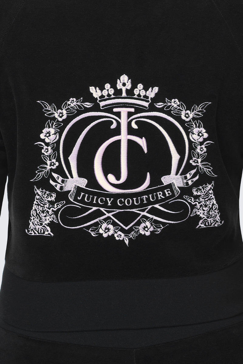 Scottie Crown Cotton Velour Jacket in black cotton velour, featuring a white embroidered graphic of a crown, a stylized JC monogram, and floral details above a banner that reads JUICY COUTURE.