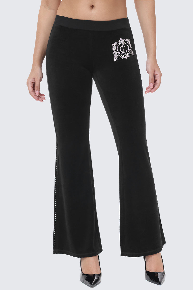Scottie Crown Cotton Velour Track Pants in black cotton velour, featuring a flared silhouette, a white crown logo on the hip, and a vertical line of rhinestones down the side.