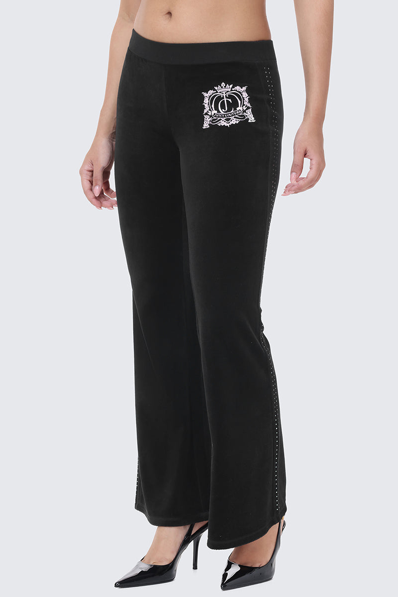 Scottie Crown Cotton Velour Track Pants in black cotton velour, featuring a white embroidered crest on the hip and a vertical row of studs along the side of each leg.