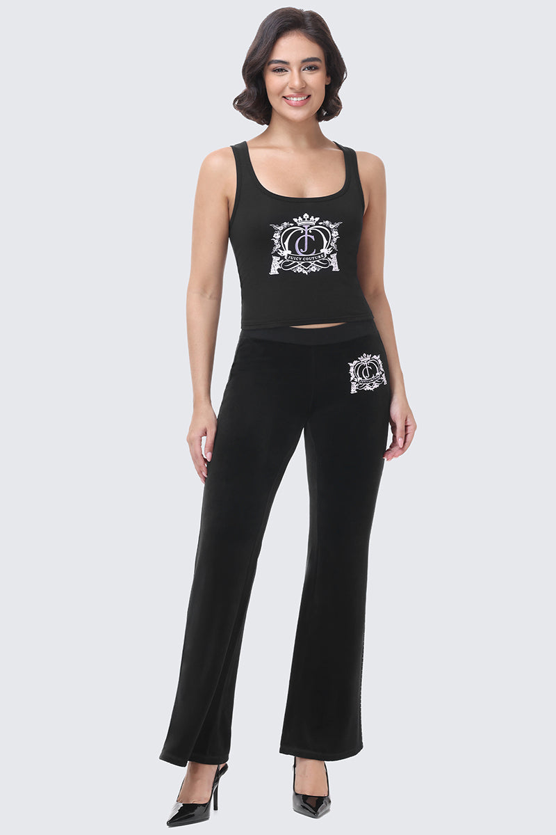 A woman wears a black cotton velour tank top and matching Scottie Crown Cotton Velour Track Pants, both featuring a white crown-and-crest logo in a sporty silhouette.
