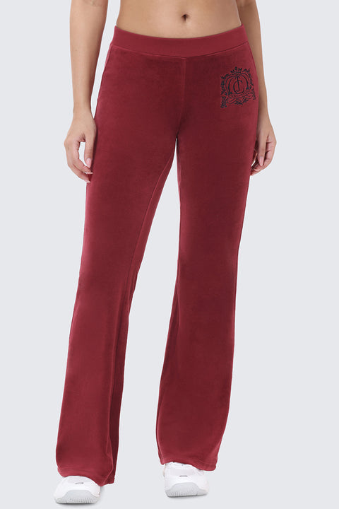 Scottie Crown Cotton Velour Track Pants in maroon cotton velour, featuring a sporty silhouette with a circular crest graphic on the left hip.