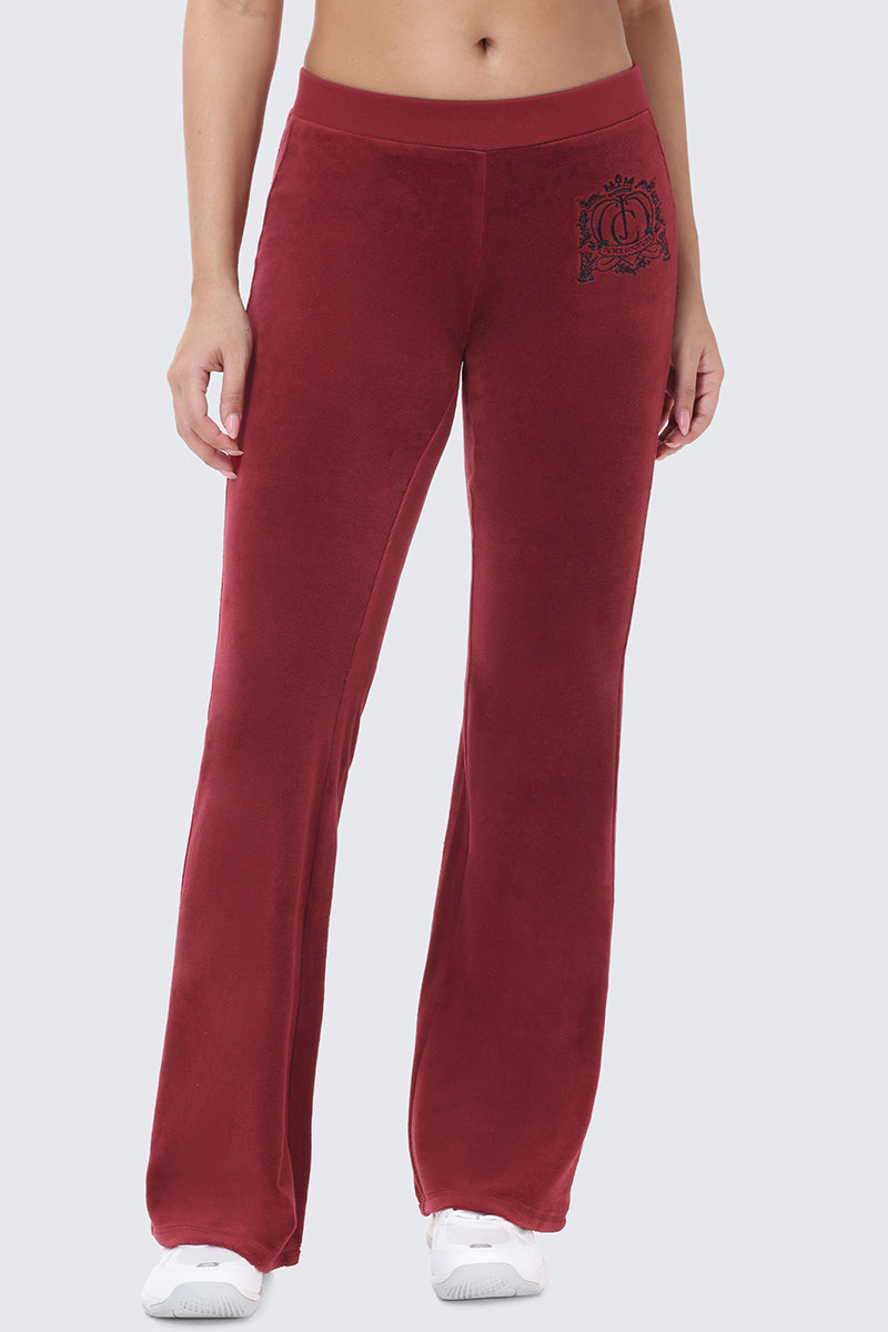 Scottie Crown Cotton Velour Track Pants in maroon cotton velour, featuring a sporty silhouette with a circular crest graphic on the left hip.