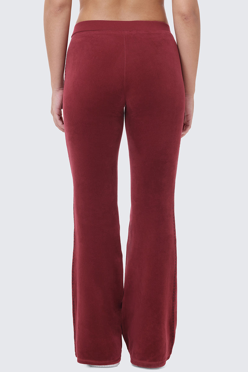 Back view of burgundy Scottie Crown Cotton Velour Track Pants, featuring a flared cotton velour design with a sporty silhouette.