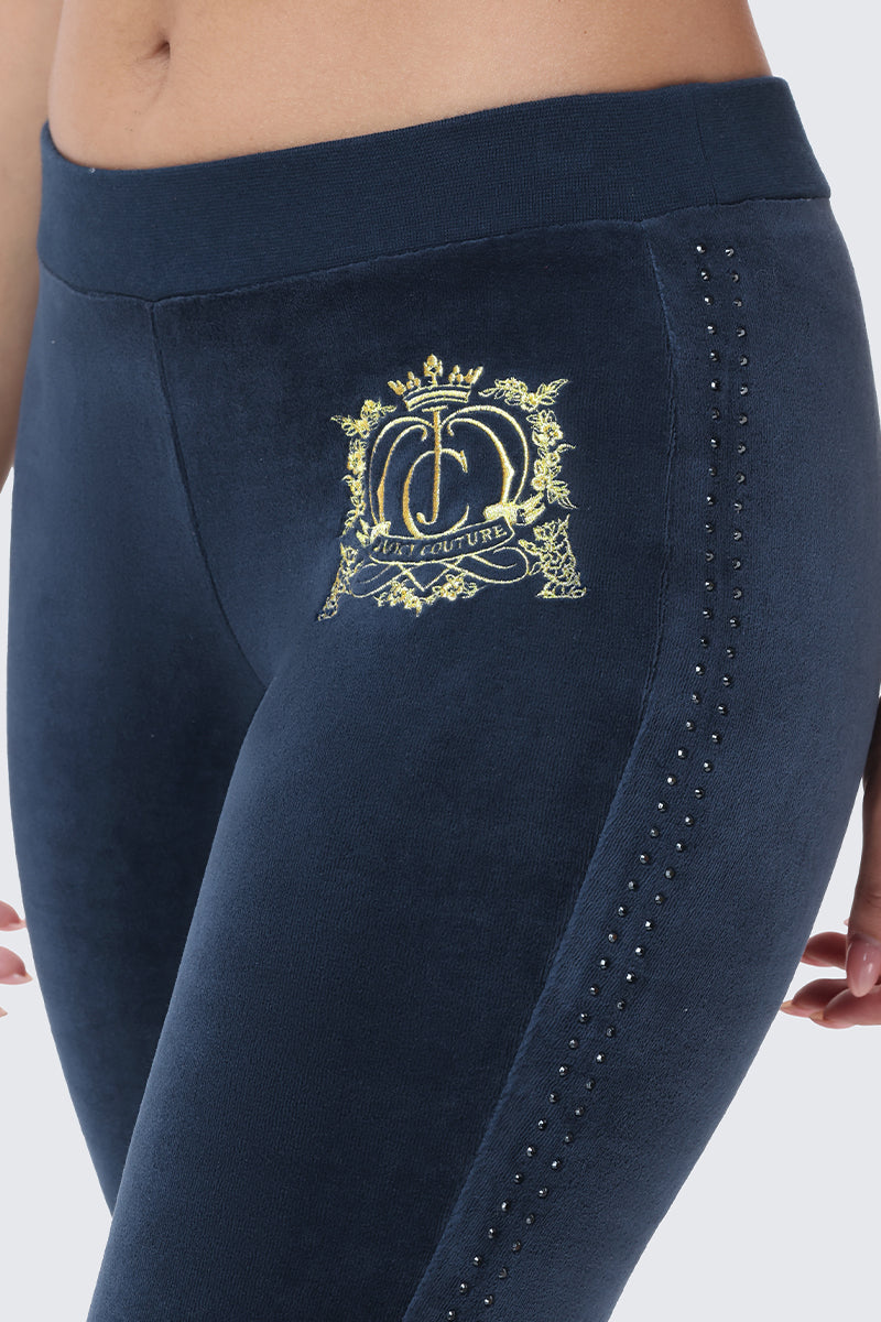 Scottie Crown Cotton Velour Track Pants in navy blue, featuring a gold embroidered crown logo on the hip and a vertical line of small dark crystals along the side.