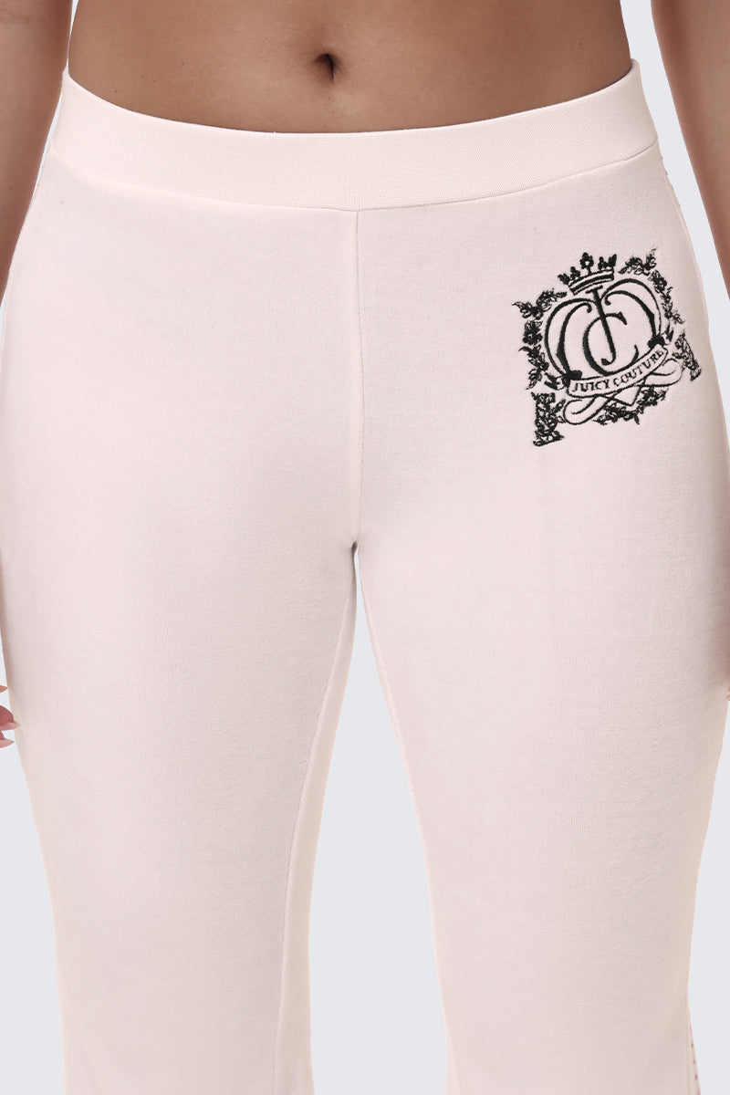 Light pink Scottie Crown Cotton Velour Track Pants in a sporty silhouette with a black embroidered crest logo on the hip.