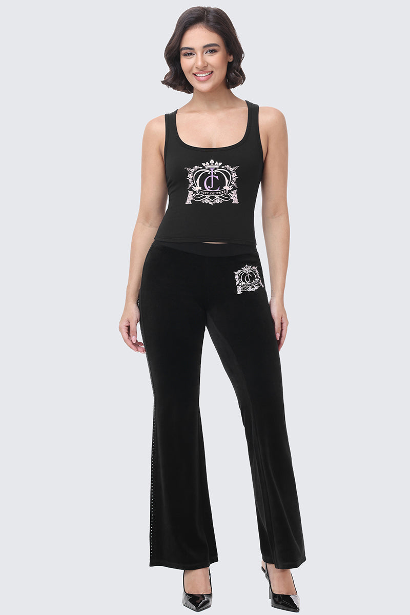 A woman wears a black Scottie Crown Tank Top and matching flared pants, both featuring a white crown logo graphic.