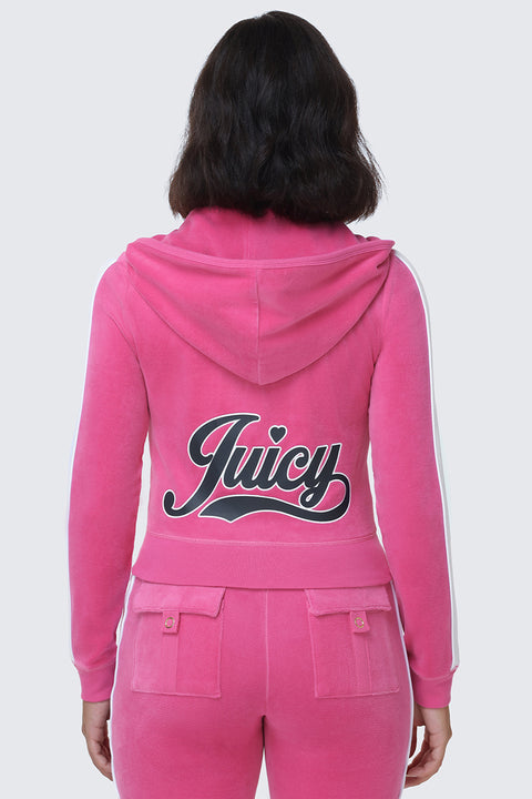 A person is seen from behind wearing the Cotton Velour Hoodie in bright pink. The hoodie features a hood and showcases Juicy’s signature script logo across the back in bold black and white lettering, complete with a small heart above the "i," highlighting the hoodie’s sporty, vibrant style.