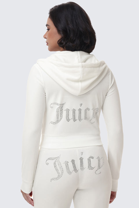 A person wearing a white OG Big Bling Velour Hoodie with a Juicy bling rhinestone logo across the back.