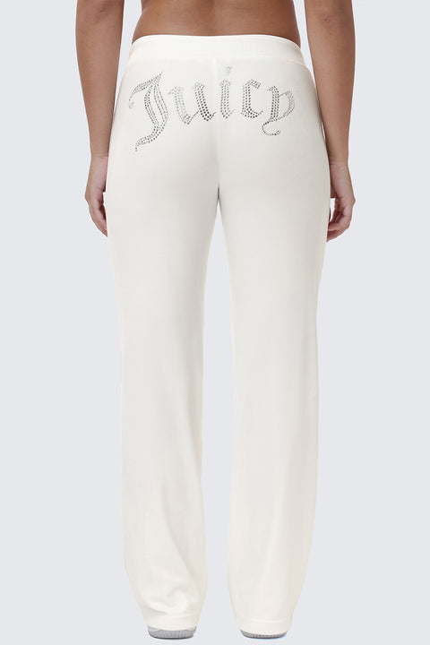 Back view of cream-colored OG Big Bling Velour Track Pants with the word Juicy spelled out in rhinestone embellishment across the seat.