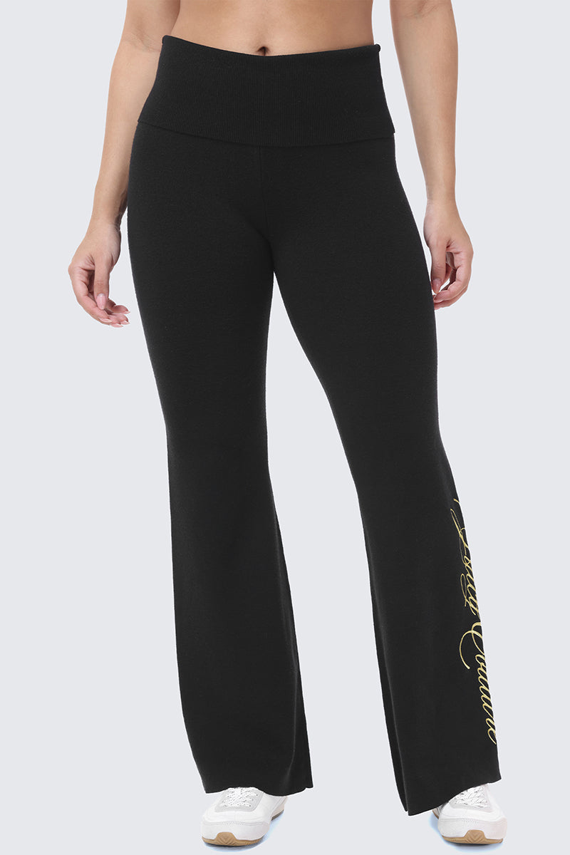 Embroidered Knit Flare Pants in black, featuring a high-rise, fold-over waistband and gold script embroidery on the lower left leg.