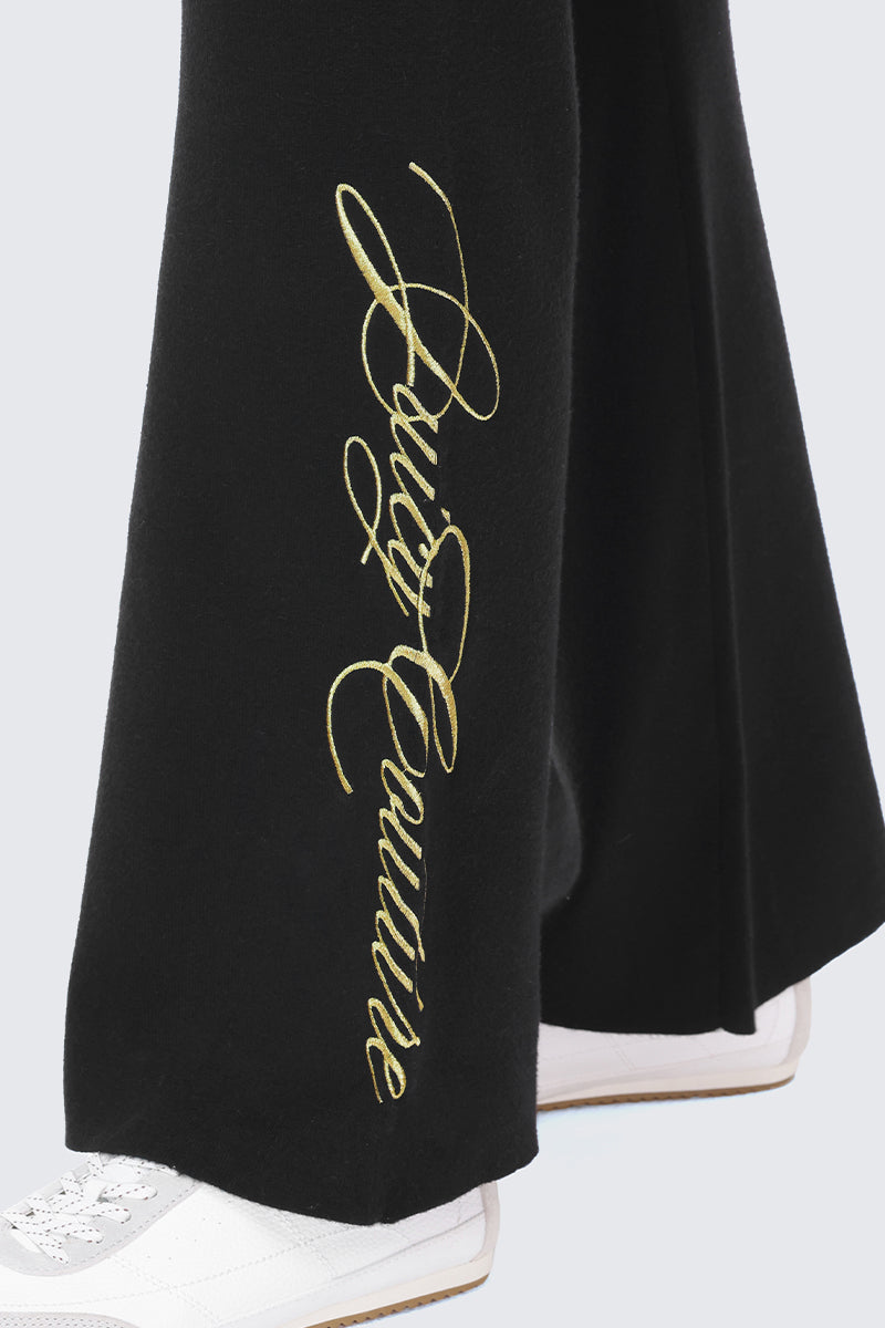 Black Embroidered Knit Flare Pants featuring gold script embroidery on the side.