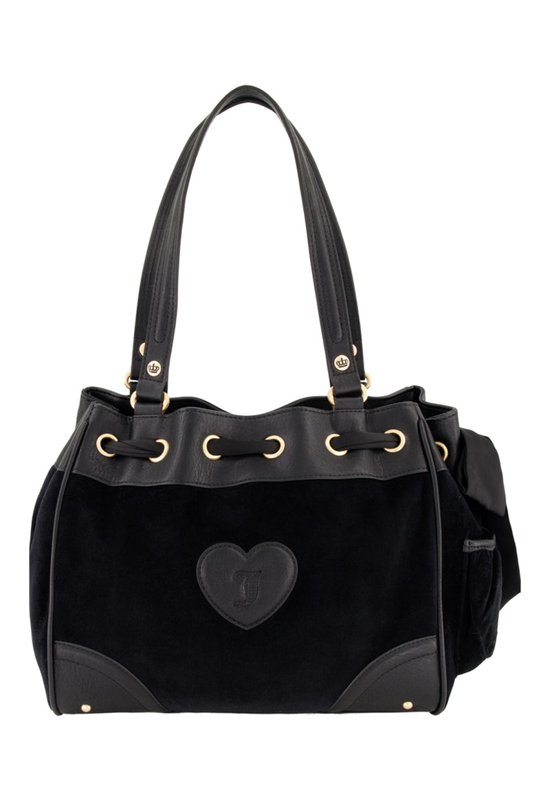 The Royal Bloom Daydreamer Tote Bag features leather straps, gold-tone eyelets, and a heart-shaped J patch on the front—blending chic Juicy glamour with structured suede and leather accents.
