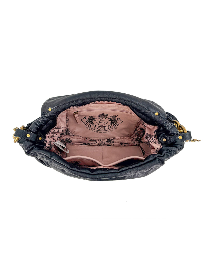 The black leather Vintage Vibes Hobo Bag features a pink fabric interior with pockets and Juicy Couture logo, plus gold hardware on the sides for a stylish touch.